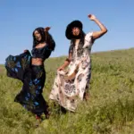 two african american women dancing in a field