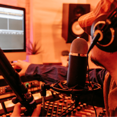 A man in a music studio with a microphone.
