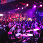 A crowd of people enjoying the vibes at a nightclub performance.