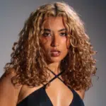 A woman in a black bikini posing for a photo.