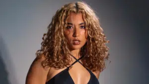 A woman in a black bikini posing for a photo.