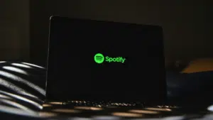 A laptop screen showcases the Spotify logo in vibrant green against a dark backdrop, hinting at the highly anticipated Spotify Wrapped experience.