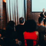 A man giving a circular presentation to a group of people.