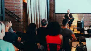 A man giving a circular presentation to a group of people.