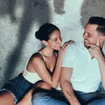 A man and woman engaging with fresh new music, sitting on the floor in front of a shadow.