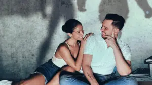 A man and woman engaging with fresh new music, sitting on the floor in front of a shadow.