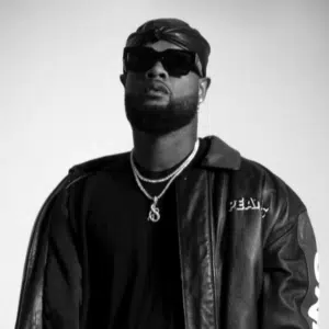 A black and white photo of a man wearing a leather jacket and sunglasses.