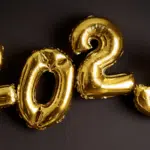 A group of gold balloons with the number 2012 on them.