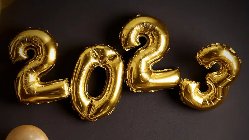 A group of gold balloons with the number 2012 on them.