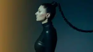 A woman sporting a fresh black leather outfit with a stylish ponytail.