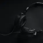 A streaming black and white photo of a pair of headphones.