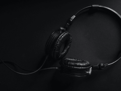 A streaming black and white photo of a pair of headphones.