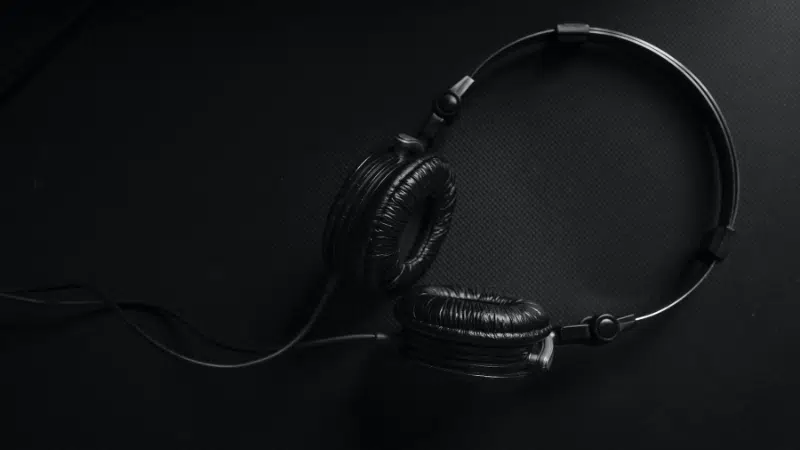 A streaming black and white photo of a pair of headphones.