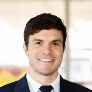 Professional man in suit smiling for a portrait.