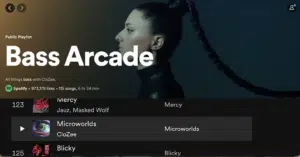 Screenshot of a Spotify public playlist titled "Bass Arcade" with a profile picture on the left of a person with long braided hair. The playlist has 115 songs and 973,179 likes. Song list starts with "Mercy".