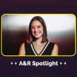 A woman smiling in front of a metallic background with the text "A&R Spotlight" below, highlighting emerging talents in music.