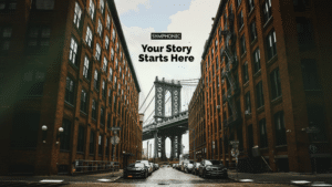 The iconic Manhattan Bridge is beautifully framed by two brick buildings, while cars are parked along the bustling street. Embrace the journey as your story starts here, with adventure and endless possibilities waiting just beyond the horizon.