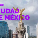 The image shows Mexico City with the Angel of Independence statue in the foreground, surrounded by modern skyscrapers under a cloudy sky.