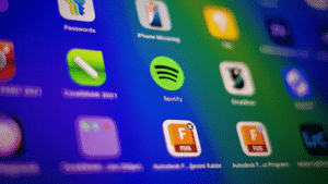 A close-up view of a digital screen displays various app icons, including Spotify and its Spotify Wrapped feature, on a colorful gradient background.