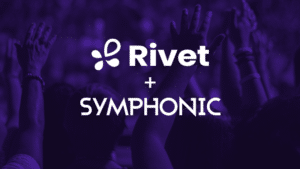 Symphonic Partners with Rivet People with raised hands in a crowd, with "Rivet + Symphonic" text overlay on a purple background.