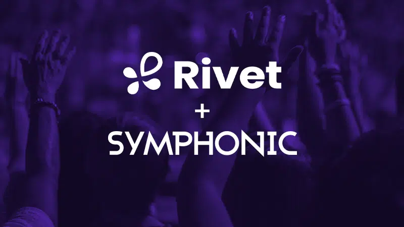 People with raised hands in a crowd, with "Rivet + Symphonic" text overlay on a purple background.