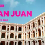 A large, historic building with multiple arches stands majestically under a blue sky, each arch whispering a story of San Juan, Puerto Rico.