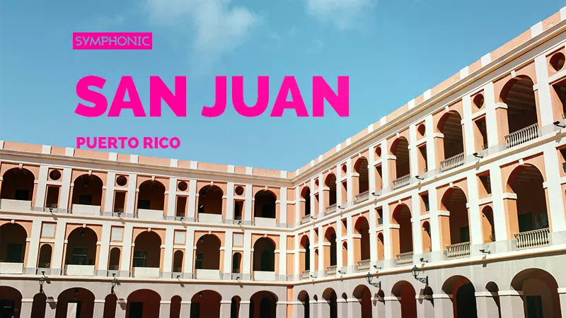 A large, historic building with multiple arches stands majestically under a blue sky, each arch whispering a story of San Juan, Puerto Rico.