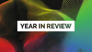 A vibrant abstract background with swirling lines sets the stage, highlighted by the text "Year in Review" elegantly placed on a crisp white rectangle.