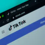 A close-up of a web browser window showcases the vibrant TikTok homepage, with its iconic logo and URL prominently displayed, capturing the essence of this dynamic platform.