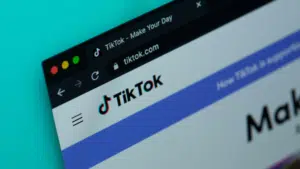 A close-up of a web browser window showcases the vibrant TikTok homepage, with its iconic logo and URL prominently displayed, capturing the essence of this dynamic platform.