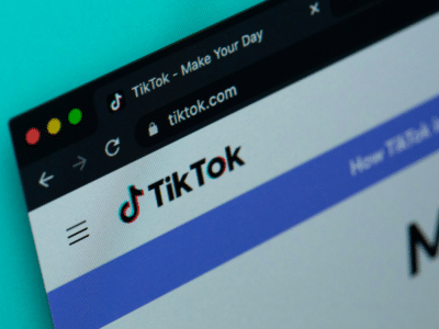 A close-up of a web browser window showcases the vibrant TikTok homepage, with its iconic logo and URL prominently displayed, capturing the essence of this dynamic platform.