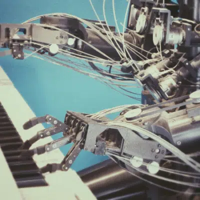 Robotic hands playing a keyboard against a blue background.