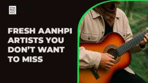 A person wearing a tan jacket and patterned bandana plays an acoustic guitar beside text celebrating AANHPI artists.