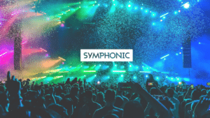 A large crowd at a concert with colorful stage lights and confetti; "SYMPHONIC" is written in bold text at the center.