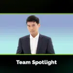 A person in a dark suit and white shirt stands against a blue gradient background, framed by a graphic with the text "Team Spotlight" below.