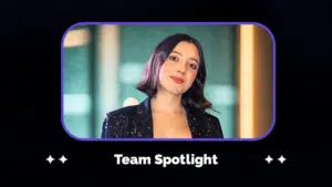 A woman with short dark hair wearing a black sequin jacket stands in front of a blurred background, representing her team. Text below reads "Team Spotlight.