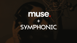 A person wearing headphones sings into a studio microphone, channeling their inner Muse, with the text "muse. + SYMPHONIC" boldly overlaid.