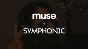 A person wearing headphones sings into a studio microphone, channeling their inner Muse, with the text "muse. + SYMPHONIC" boldly overlaid.