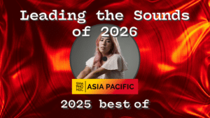 A person with long pink hair sits in front of a red vinyl record background, with the text: "Leading the Sounds of 2026, Symphonic Asia Pacific, 2025 best of.