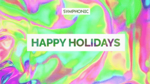 Text reads "SYMPHONIC," "HAPPY HOLIDAYS," and highlights a year in review over a bright, iridescent background with swirling pastel colors.