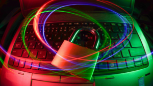 A padlock sits on a laptop keyboard with swirling red and blue light trails, representing cybersecurity, data protection, and copyright security in the digital world.