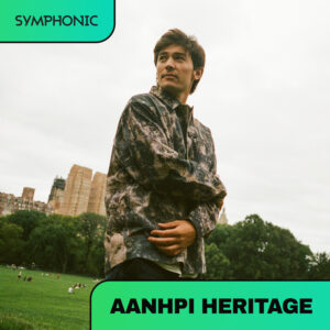A person stands in a grassy park with buildings and trees in the background. The image features text: "SYMPHONIC," "AANHPI HERITAGE," and highlights a special playlist celebrating cultural heritage.