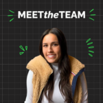 A woman with long dark hair in a tan fleece vest and white shirt smiles as part of the team in front of a "MEET the TEAM" graphic on a black grid background with green doodles.