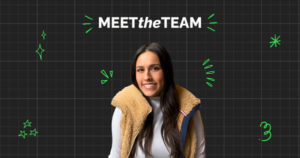 A woman with long dark hair in a tan fleece vest and white shirt smiles as part of the team in front of a "MEET the TEAM" graphic on a black grid background with green doodles.