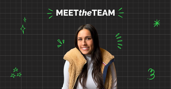 A woman with long dark hair in a tan fleece vest and white shirt smiles as part of the team in front of a "MEET the TEAM" graphic on a black grid background with green doodles.