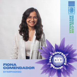 A woman with long dark hair and glasses smiles at the camera. Text reads “Fiona Comendador, Symphonic, 2026 Conference Speaker, Indie-Con Australia.”.